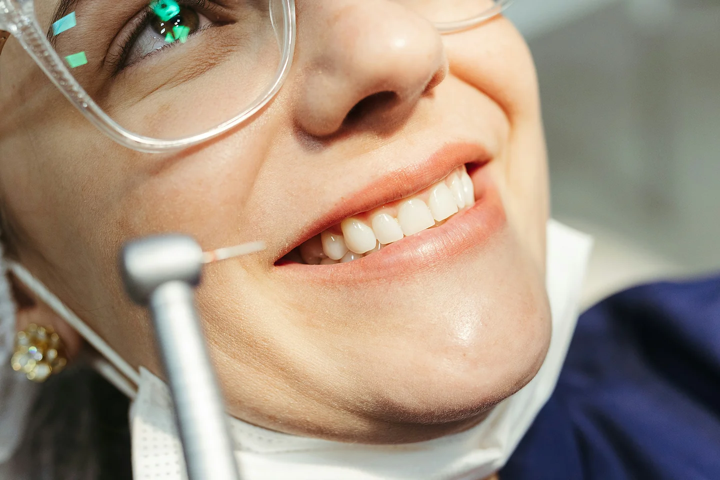 Lächelnde Patientin mit Schutzbrille